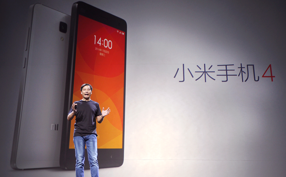 Xiaomi founder Lei Jun stands beside an image of the new Mi4. Photo: Simon Song