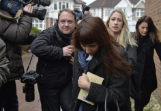 Italian sisters Elisabetta (R) and Francesca (C) Grillo are surrounded by members of the media as they arrive at Isleworth Crown Court in west London Photo: Reuters