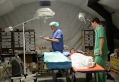 Norwegian surgeon Andreas Odegaard (right) talks to a patient inside the operating tent of the Red Cross tent hospital in Basey town. Photo: AFP