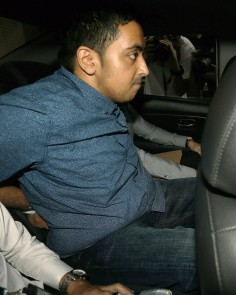 Briton Yogvitam Pravin Dhokia, 27, arrives in a police car at the state court in Singapore. Dhokia was charged with  committing a "rash act" that endangered the lives of drivers. Photo: AFP