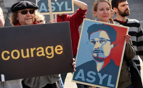 German Demonstrators hold a poster of fugitive US intelligence leaker Edward Snowden as they lobby for an appearance by Snowden as a witness in German NSA hearings. Photo: AFP