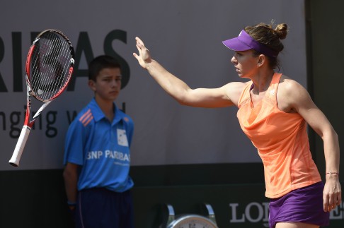 Romania's Simona Halep throws her racquet after losing a point against Spain's Maria-Teresa Torro-Flor during their French Open third-round match. Photo: AFP