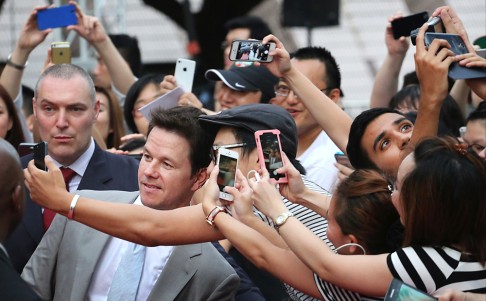 Actor Mark Wahlberg arrives on the red carpet for the world premiere of the film Transformers: Age of Extinction, at Cultural Centre in Tsim Sha Tsui. He complimented the city where shooting took place last October. Photo: Felix Wong