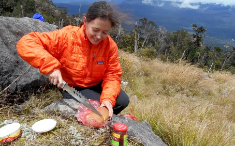 Sophie on a lunch break on the 20-mile hike in to the base camp of Mount Giluwe, Papua New Guinea. Photo: Sophie Cairns