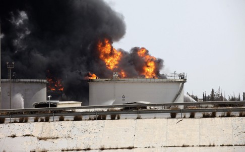 Fires burning at a fuel depot near the airport road in Tripoli. Photo: Reuters