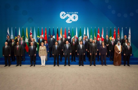 Tony Abbott stands next to Xi Jinping and Shinzo Abe at the G20 summit in Brisbane, with Putin relegated to the side. Photo: Reuters