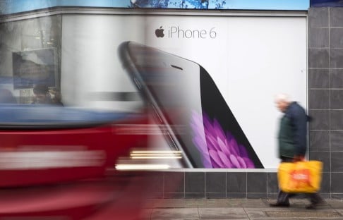 A man walks past an advert for the iPhone 6. Photo: Reuters