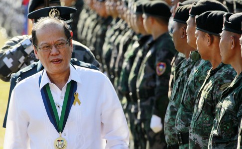 President Benigno Aquino walks past troops during the 29th Presidential Security Group (PSG) anniversary in Manila on March 10, 2015.  Photo: Reuters