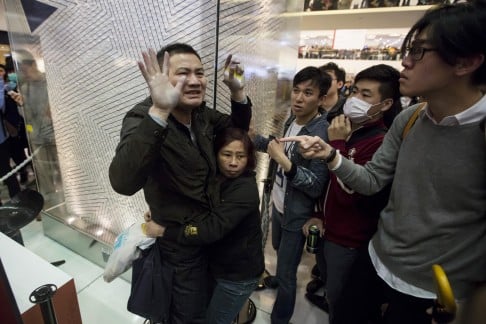 Protesters clash with a mainland traveller during a rally against parallel trading. Photo: Reuters