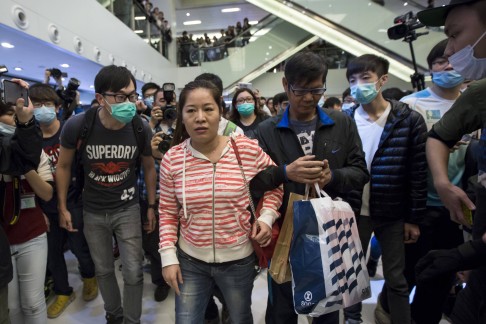 Protesters wearing masks shout at mainland Chinese travellers during a demonstration inside a shopping mall in Hong Kong. Photo: Reuters