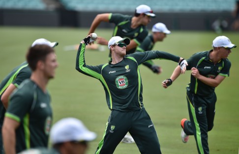 Australia cricketer Steve Smith (centre) throws a ball during training in Sydney. Photo: AFP