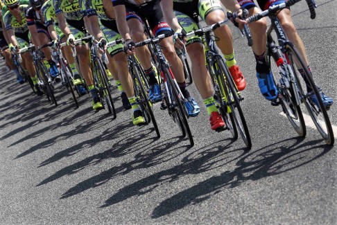 Riders cast their shadows onto the road during the 13th stage of the Tour de France. Photo: Reuters