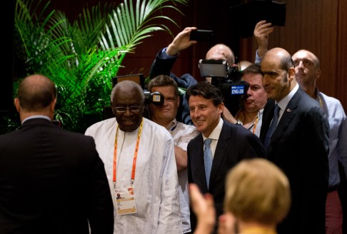 IAAF outgoing president Lamine Diack with his newly elected successor Sebastian Coe arrive for a press briefing in Beijing. Photo: AP