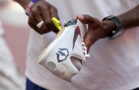 Mo Farah adjusts his spikes inside the Bird's Nest Stadium at a practice session ahead of the athletics World Championships. Photo: Reuters