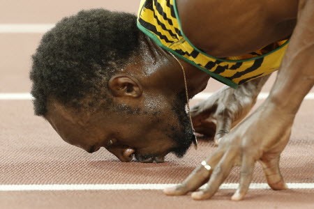 Jamaica's Usain Bolt kisses the track after winning the final of the men's 200 metres. Photo: AFP