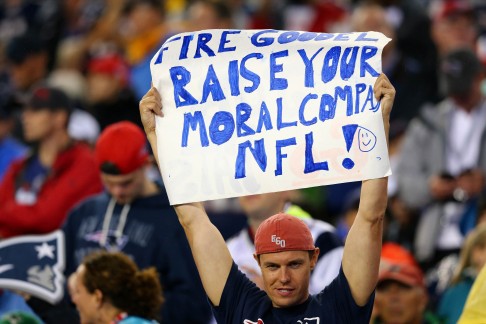 A spectator holds out a sign directed at NFL commissioner Roger Goodell. Photo: AFP