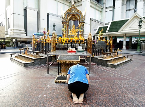 A woman worships to a statue of Lord Brahma, the Hindu God of Creation, at the Erawan Shrine in Bangkok last week. Photo: EPA