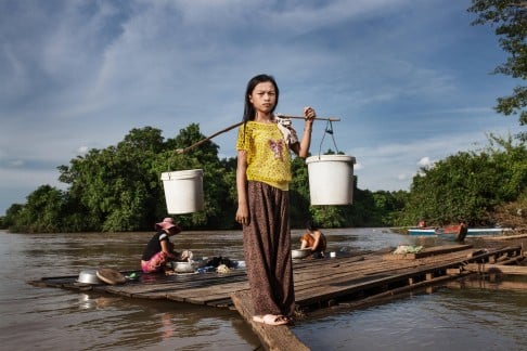 Villagers from Phluk, downstream from the site of the Lower Sesan 2 Dam, in Stung Treng province, northern Cambodia. The construction of the dam has led to a significant drop in fish stocks, according to locals, whose main source of food and income is the river.