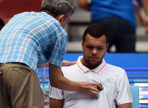 Jo-Wilfried Tsonga of France receives medical treatment during his first-round men's singles match against Andreas Haider-Maurer of Austria. Photo: AFP