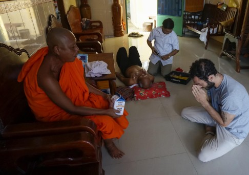 Author Nathan Thompson pays his respects to the head monk in Baray.