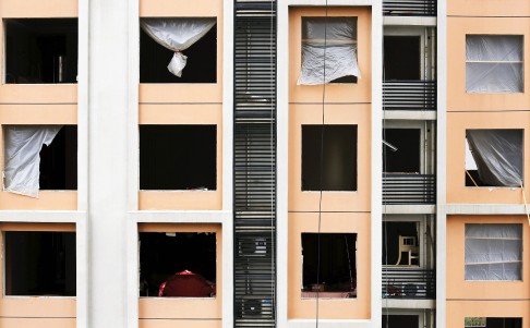 Shattered windows are seen on the facade of a residential building near the site of a series of explosions in Tianjin the day after the blasts. Photo: Reuters