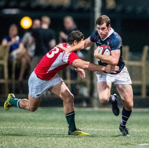 Hong Kong fullback Ed Rolston (right) tries to brush off Portugal's Jose Lima at HKFC.