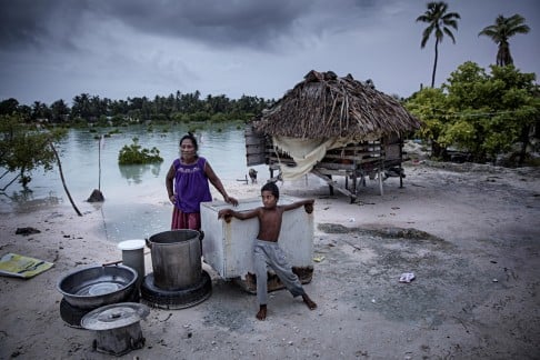 Takenamoone Tekiari’s home in Tarawa floods at high tide.