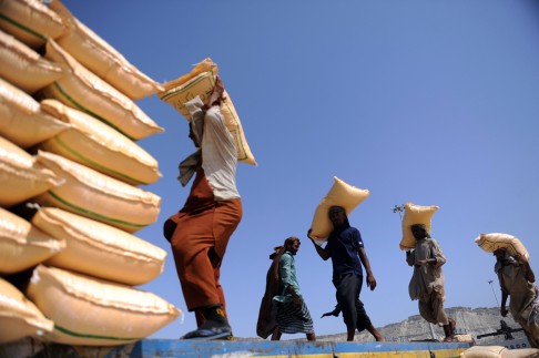 Dockers carry feed bags at the pier of Gwadar Port. Locals tend to be offered only menial jobs in the town.