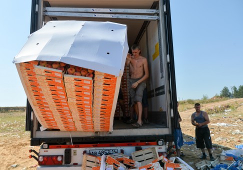 Fruit smuggled into Russia in breach of an embargo on imports is destroyed last August, outside the city of Novozybkov. Photo: AFP