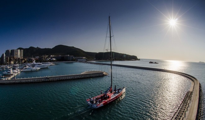 A boat sails in Sanya Serenity Marina when sun sets.